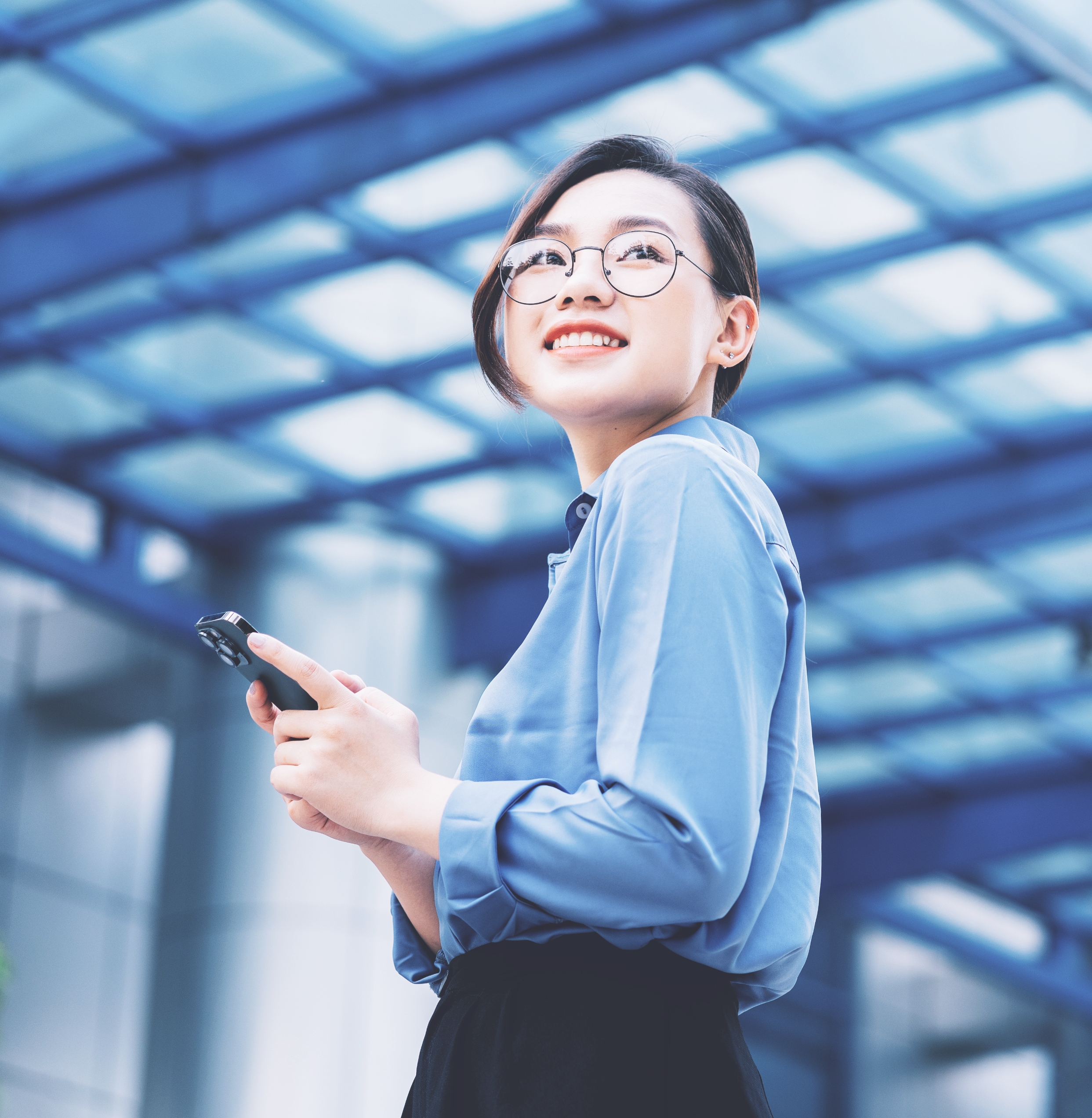 Young Asian businesswoman holding phone