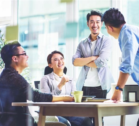 Office colleagues smiling and having a conversation