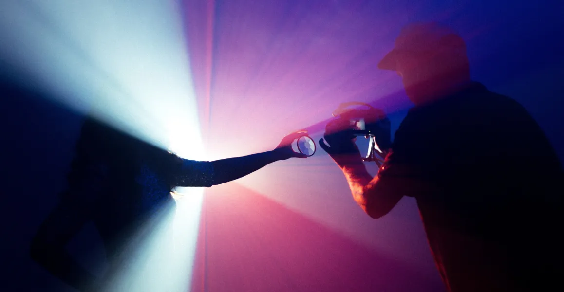 Photographer taking a shot of the light from a prism