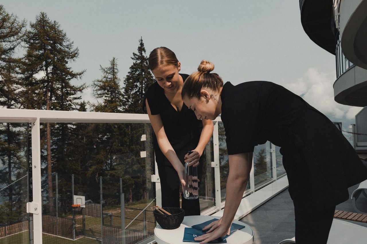 Two employees setting up a table.