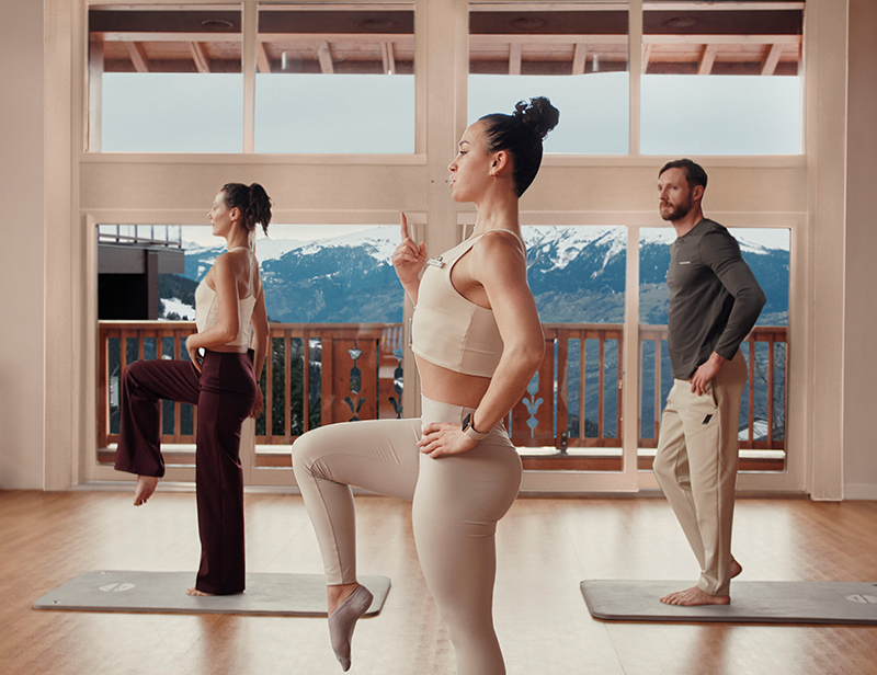 A G.O yoga teacher teaching a yoga session with two clients