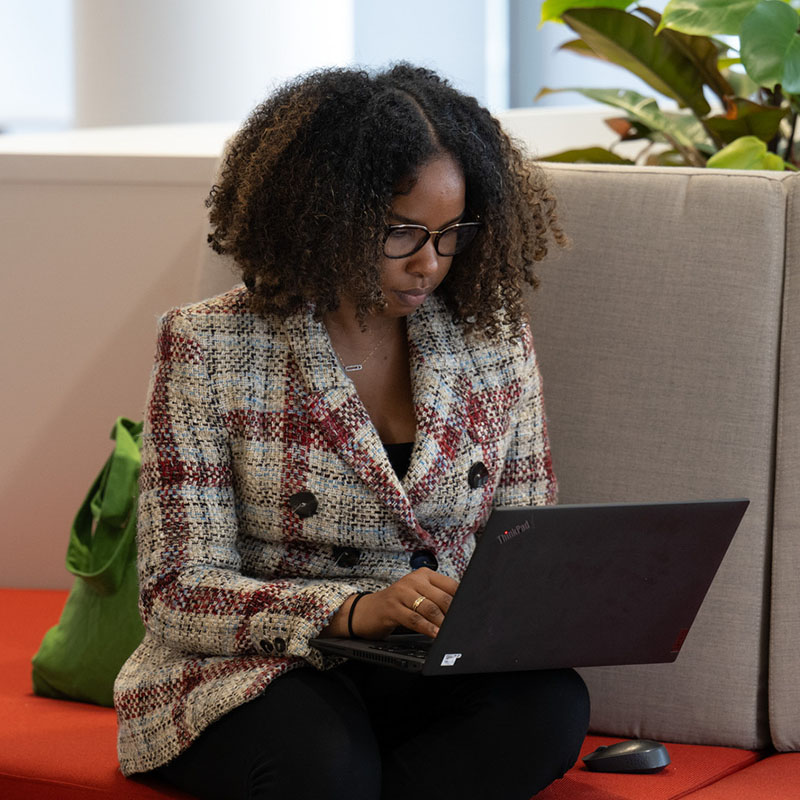 Woman focused on work using laptop.