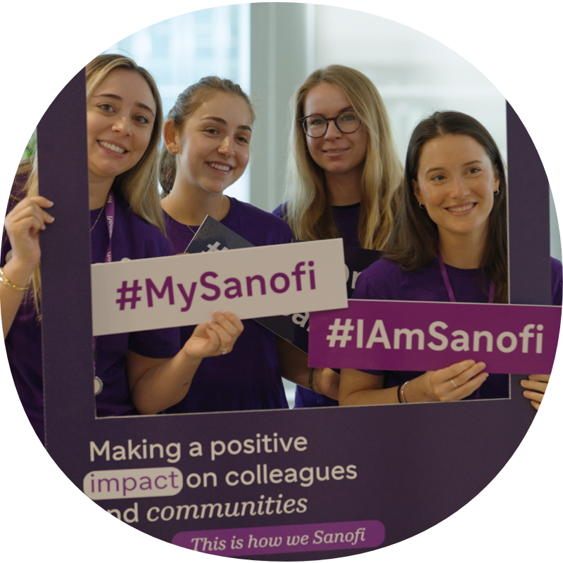 Group of 4 women holding Sanofi signs
