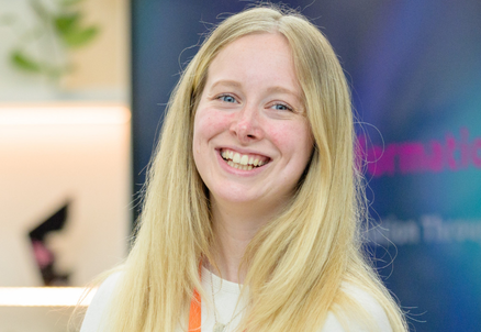 Smiling woman with long blonde hair indoors