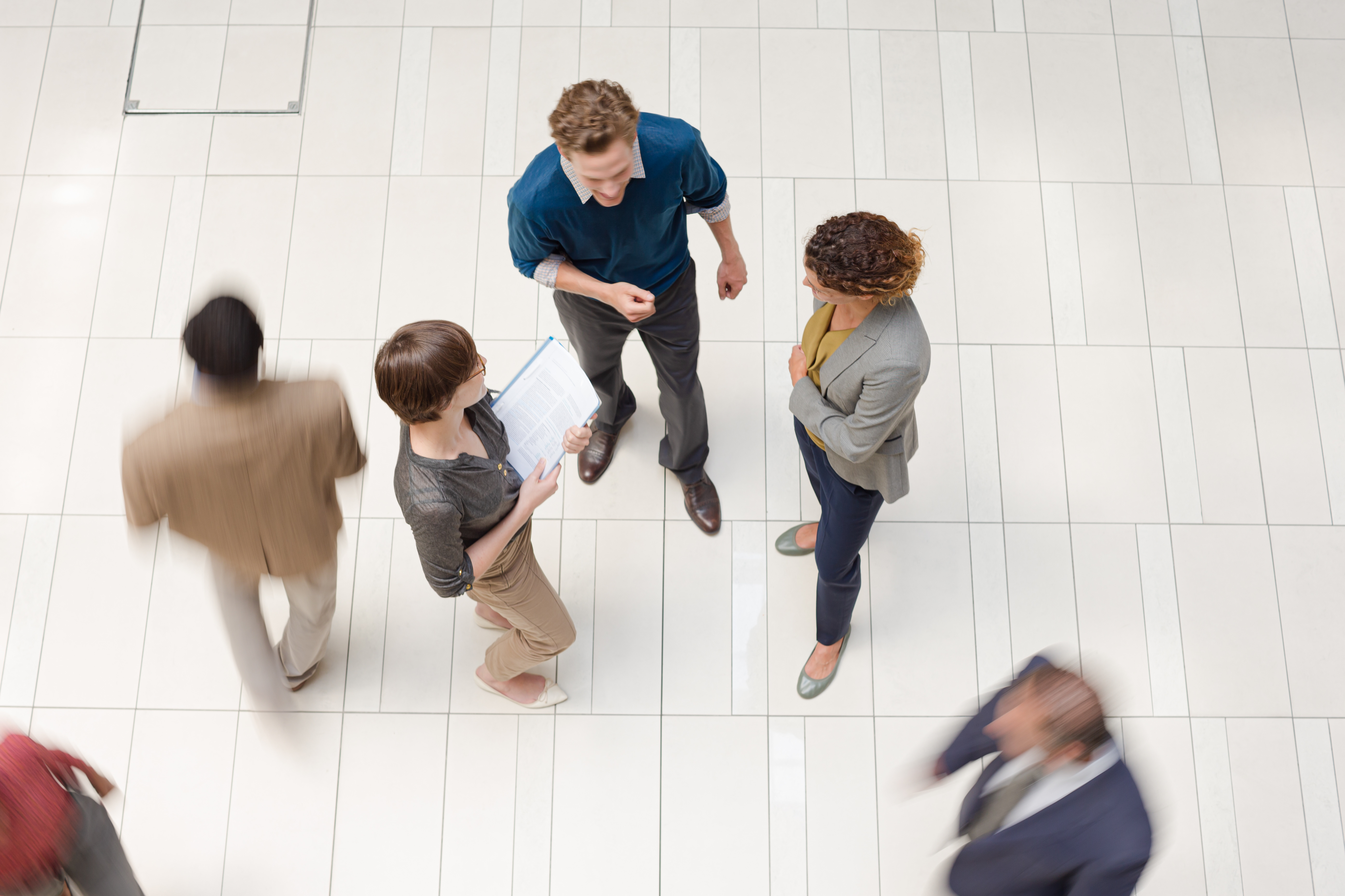 Group of employees standing around the office