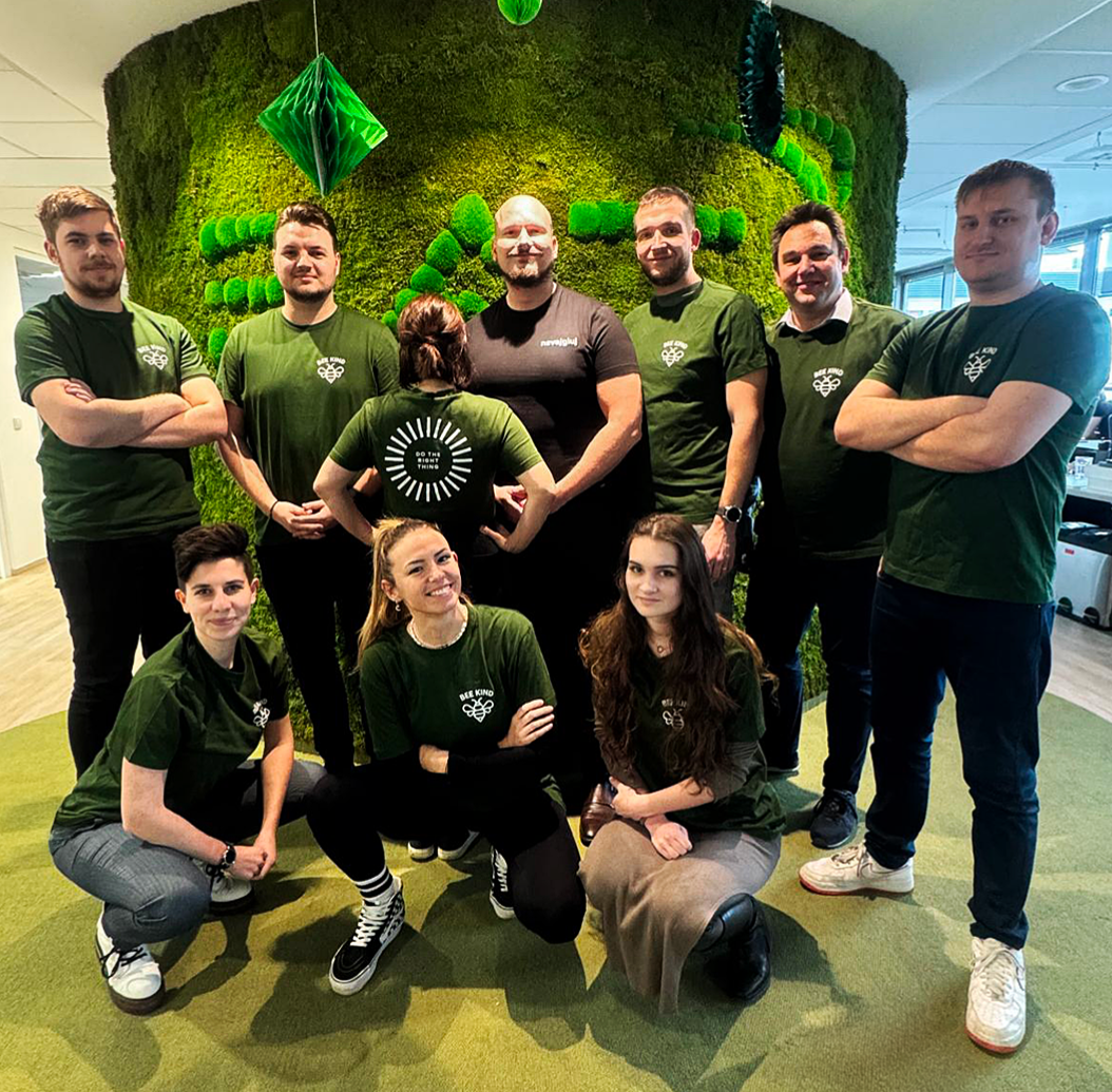 A group of employees from the BAT Czech Republic office wearing green shirts with Do The Right Thing value logo.