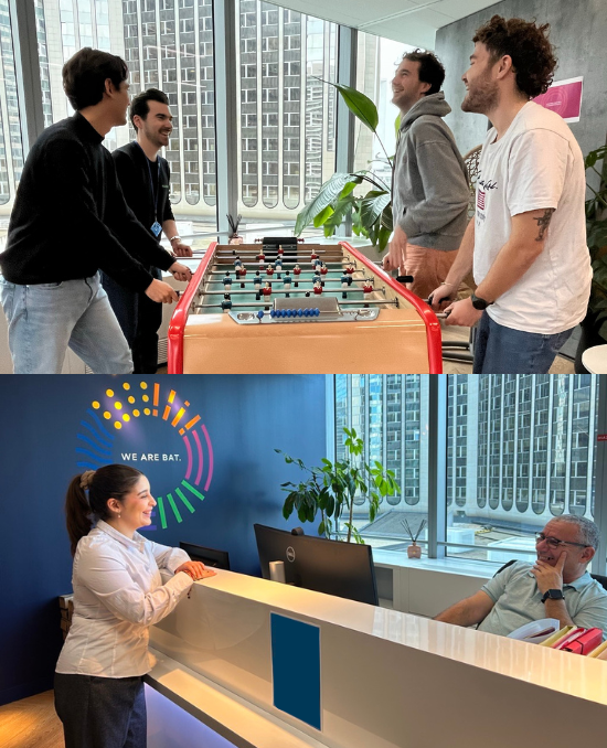 A group of employees playing foosball and employees speaking to eachother