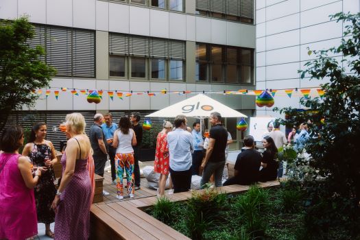 A work event held outside on a terrace with multiple employees.