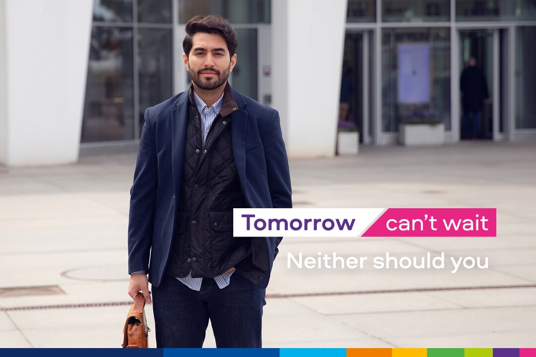 Person in suit walking outdoors, slogan overlay