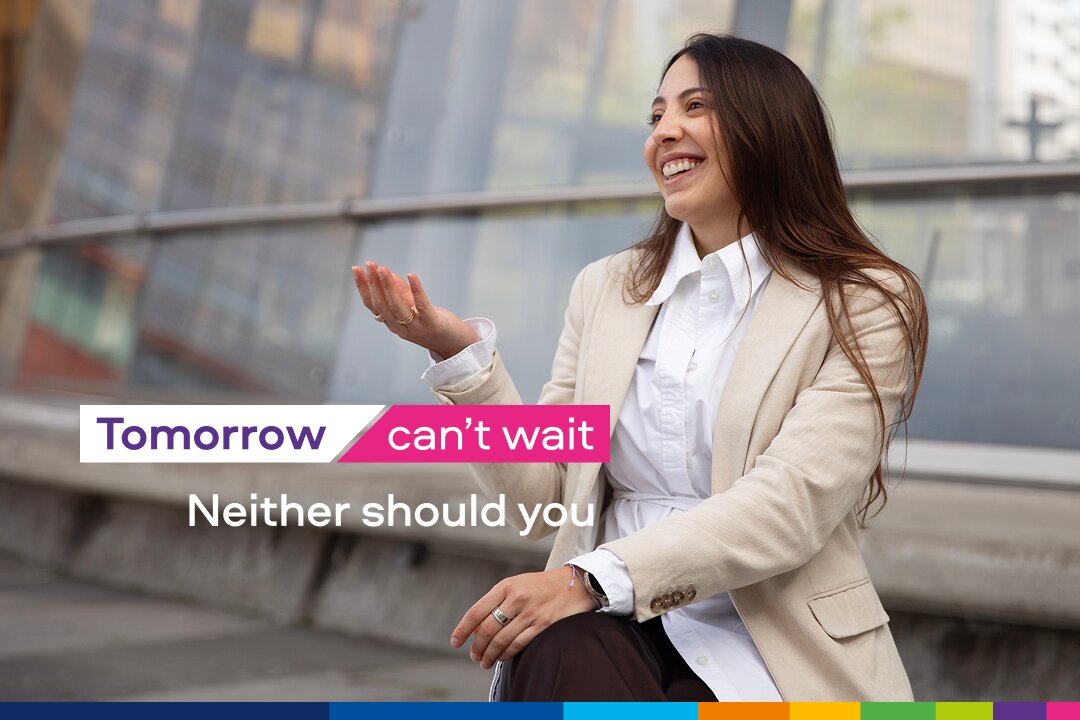 Person in blazer gesturing near slogan text