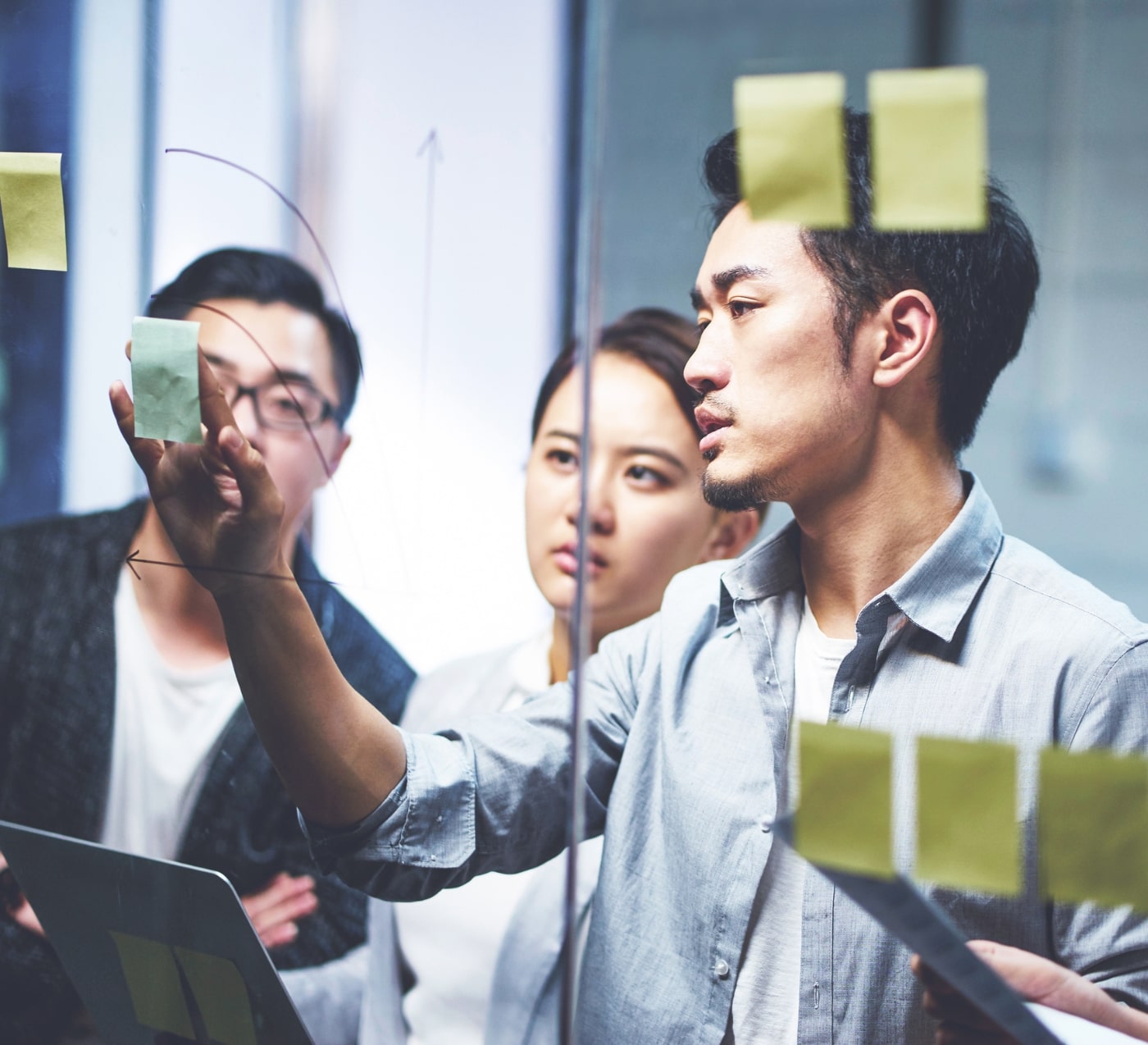 three people smiling alongside eachother