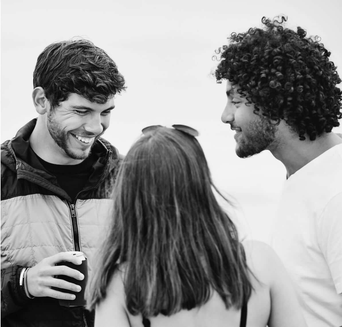 three people smiling alongside eachother