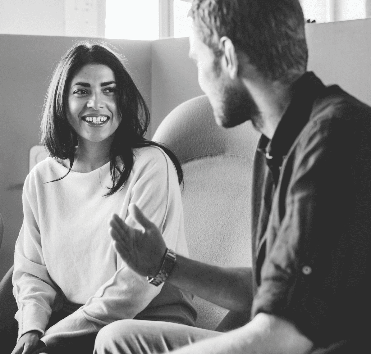 Woman and man talking while sitting on a couch