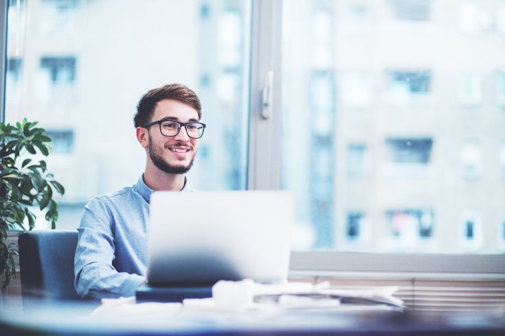 Person using a laptop in a modern office setting