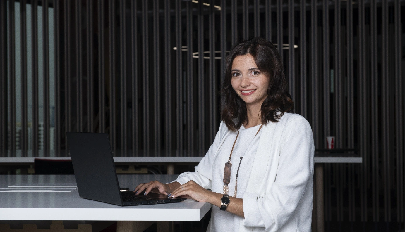 Person using a laptop at an office desk