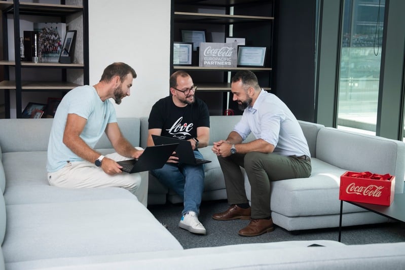 Team members discussing work in a modern office space