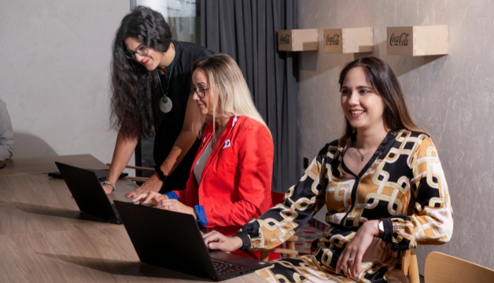 Team working on laptops at meeting table