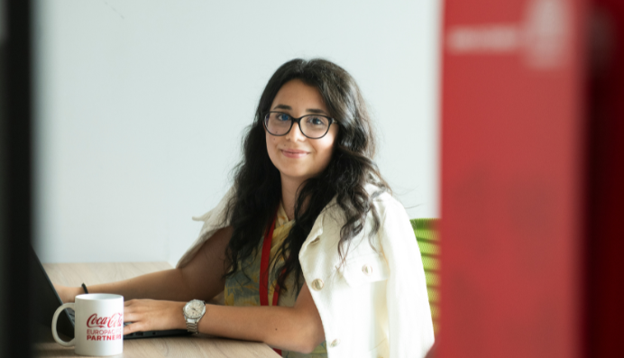Woman smiling at desk with laptop