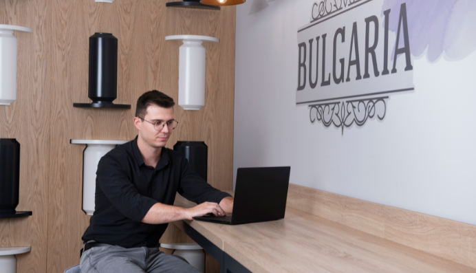Man working on laptop at wooden desk
