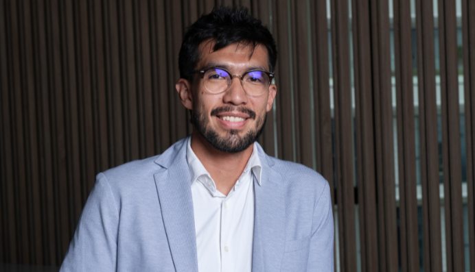 Person in light blazer against vertical panel wall