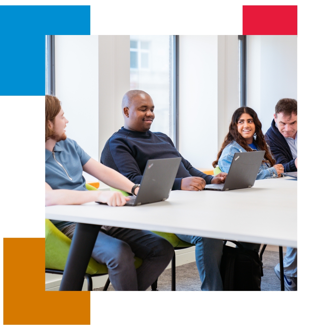 Man and 2 women working at computer