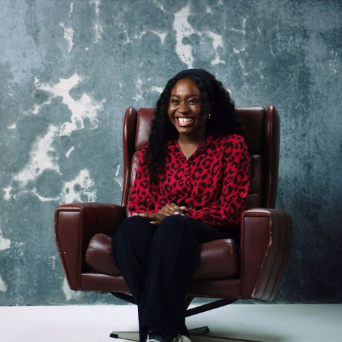 Person smiling while seated in chair