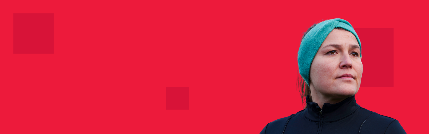 Red background with dark square pixels on with a woman in a headband looking to the right