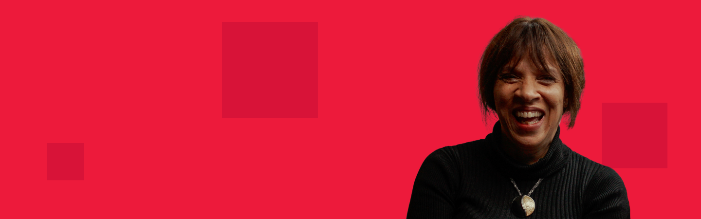 Woman in a black top against a red background with dark red pixels on it