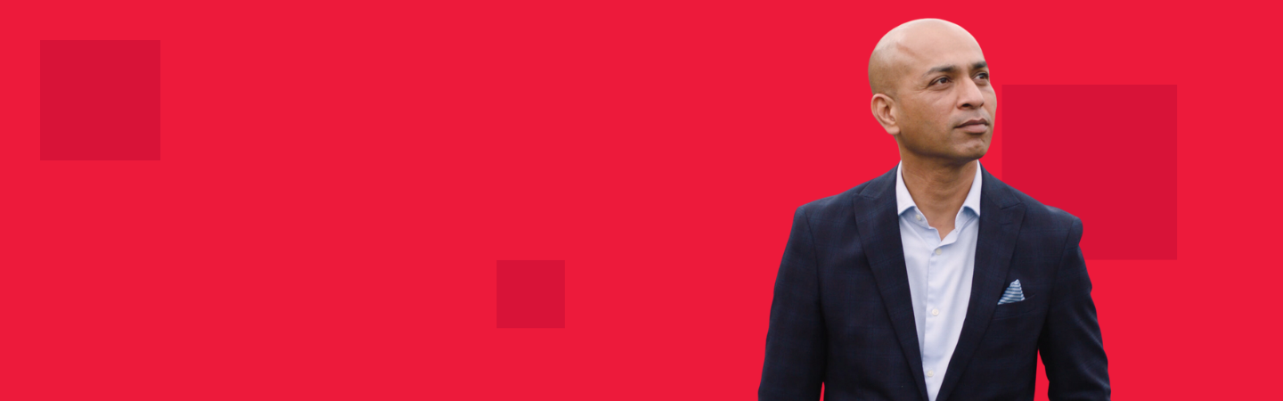 Man in suit looking up to the sky with red background and dark red pixels on top