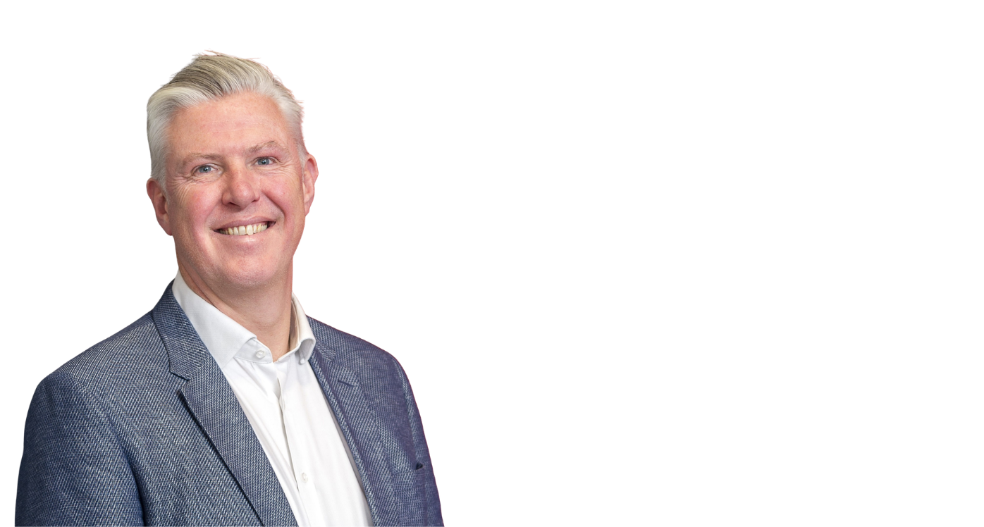 Man with white hair and grey suit jacket with white shirt, smiling