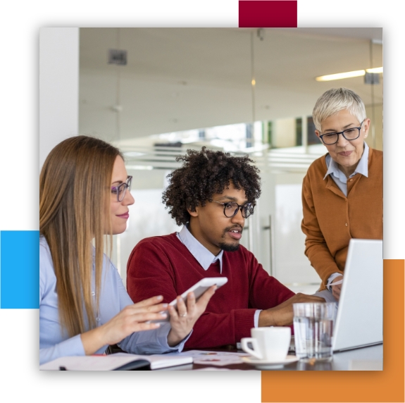 Man and 2 women working at computer