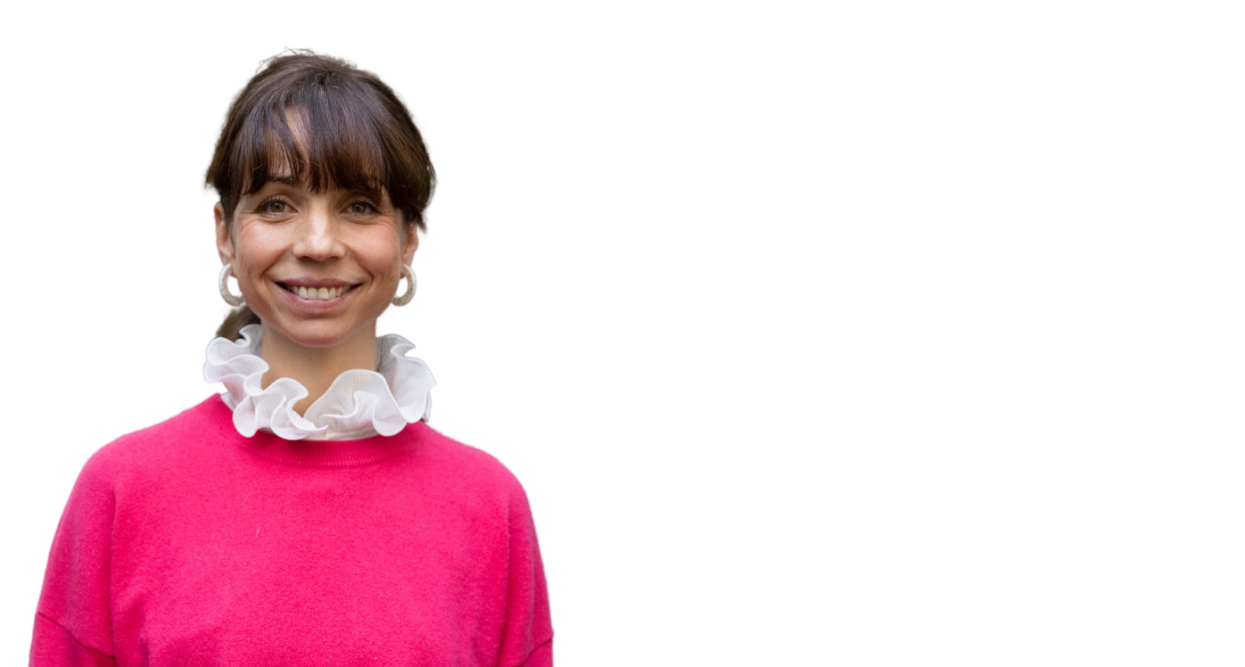 Woman in pink jumper smiling at the camera