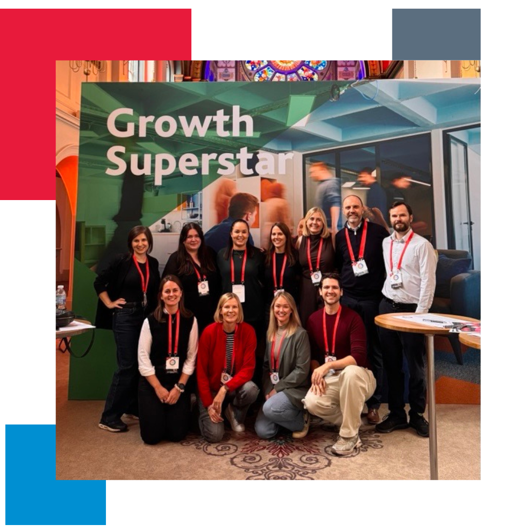 Group of people inside a cathedral stood in front of a banner which says growth superstar on it