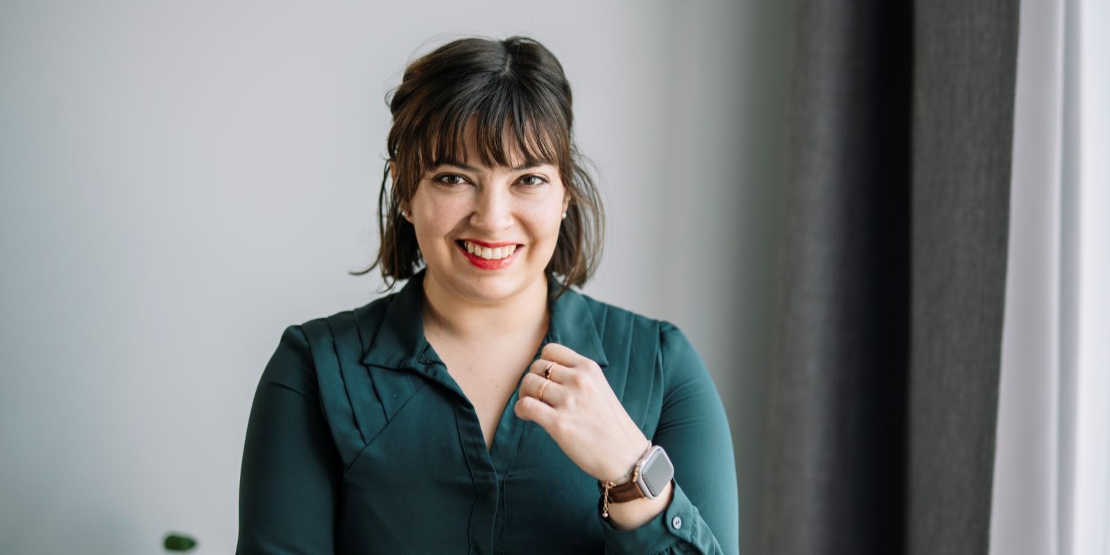 A woman smiles at the camera