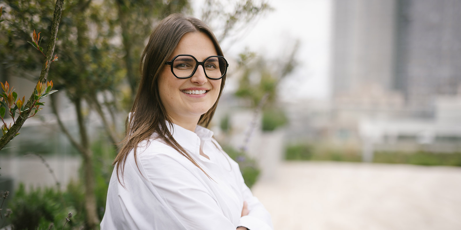 Melissa is wearing glasses and a white shirt