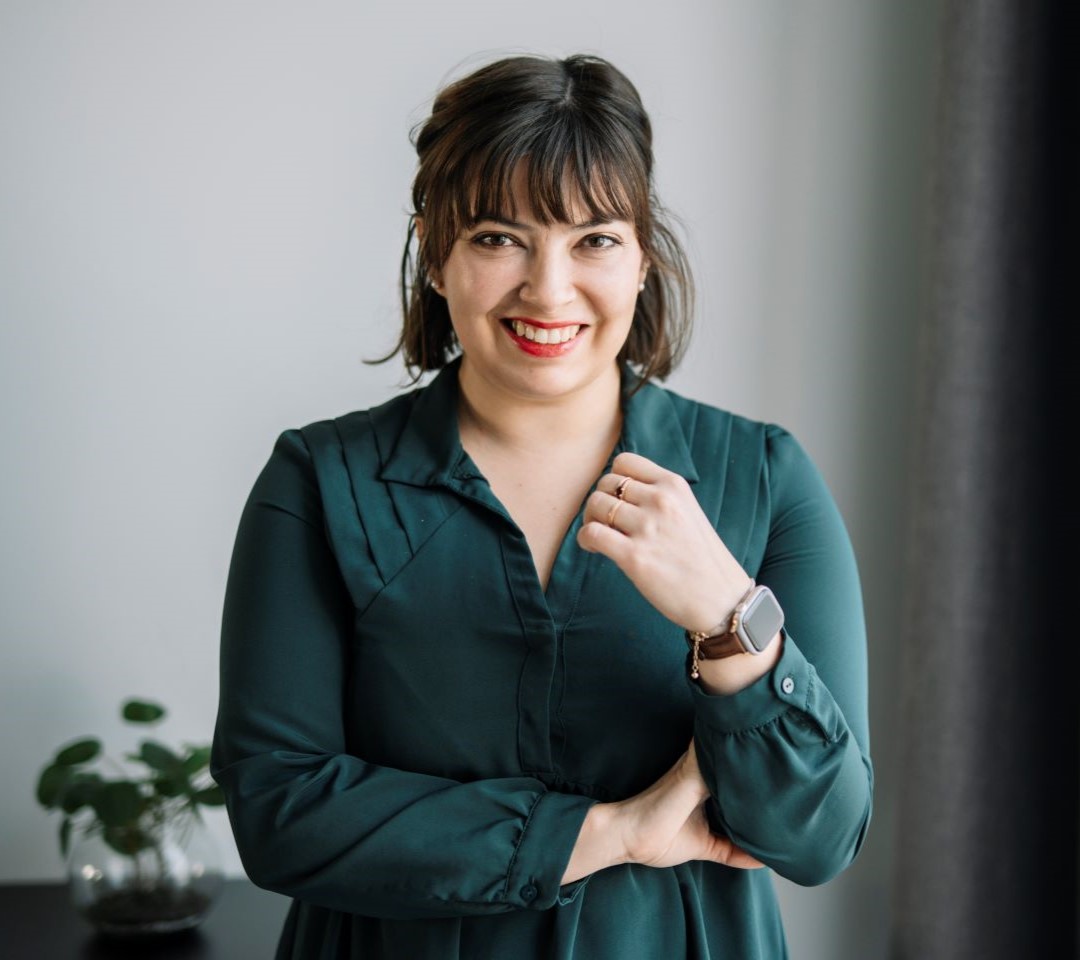 Claire is smiling at the camera.