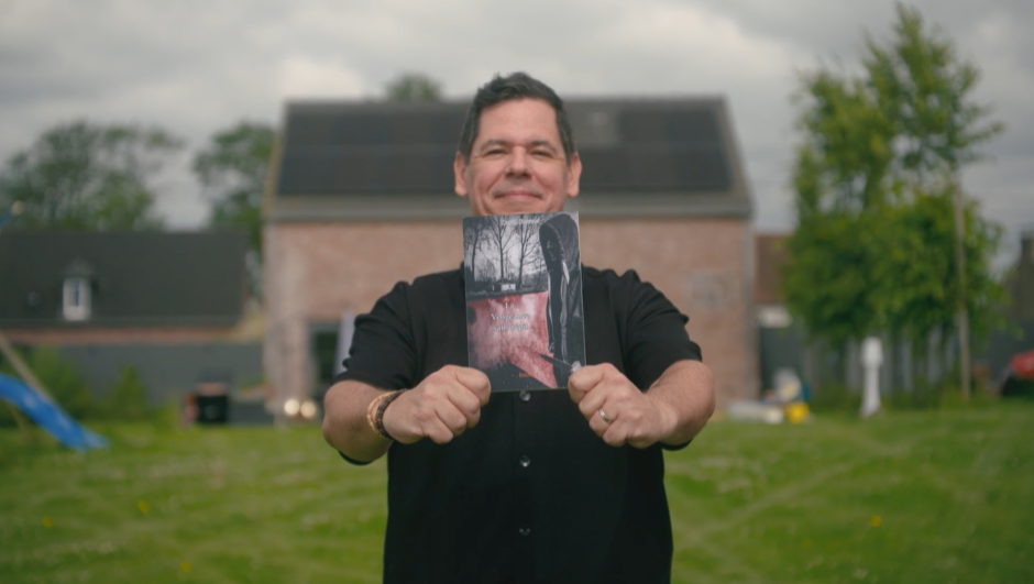 David is holding his book in front of him