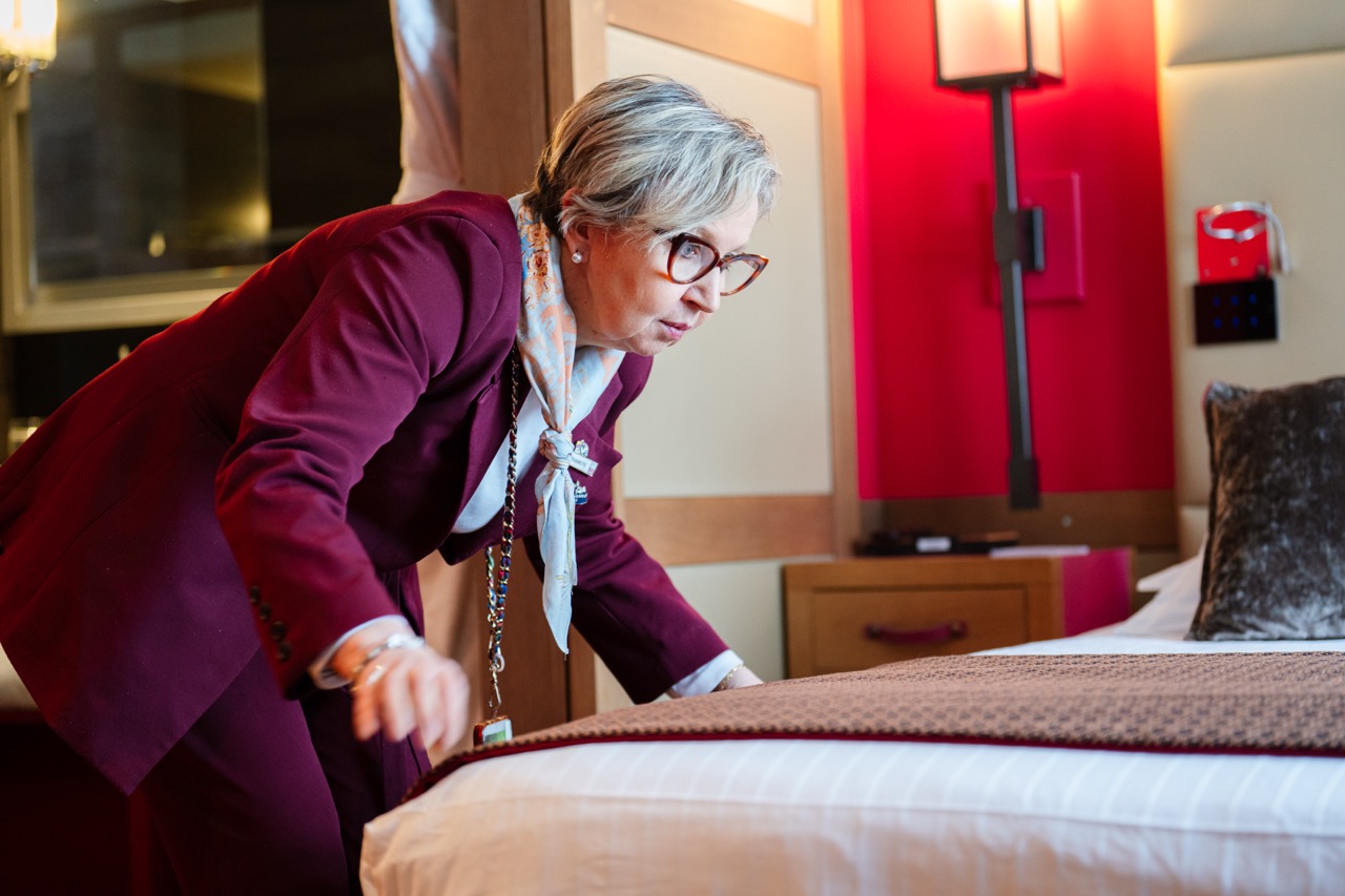 A housekeeper preparing a bed