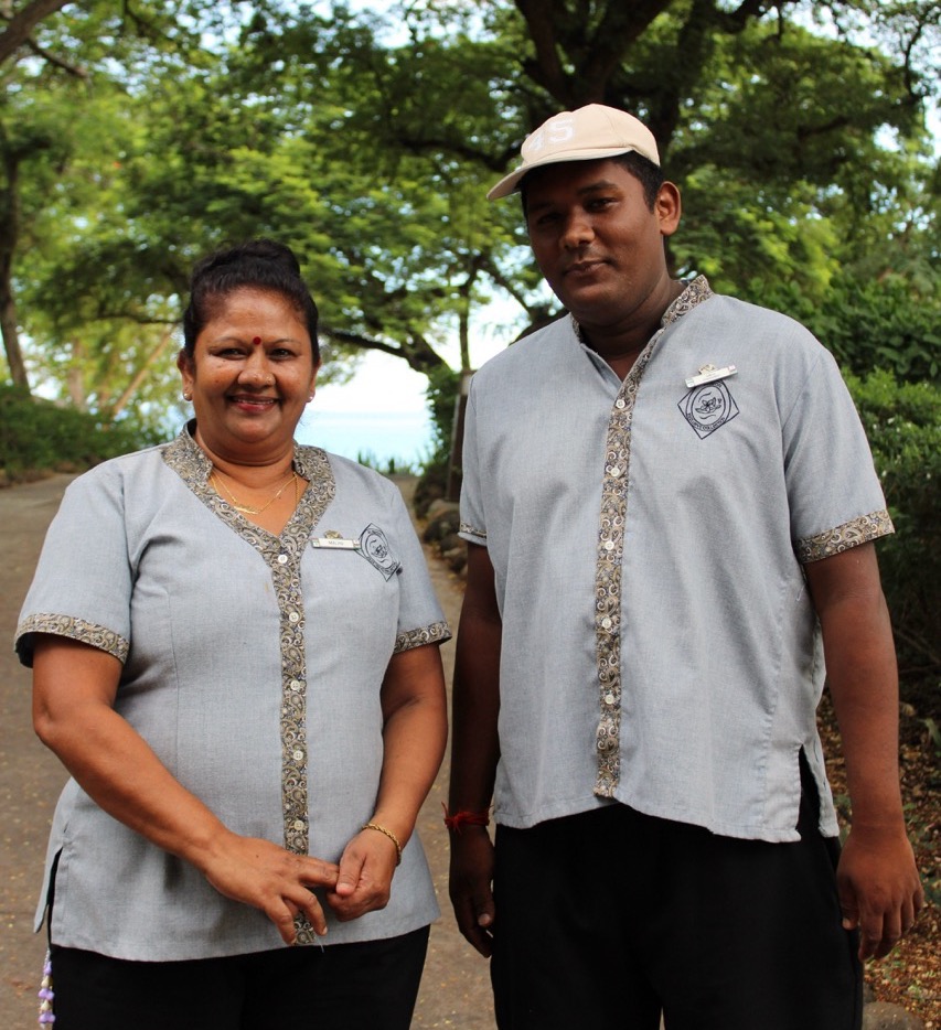 Two housekeepers posing for a picture outside.