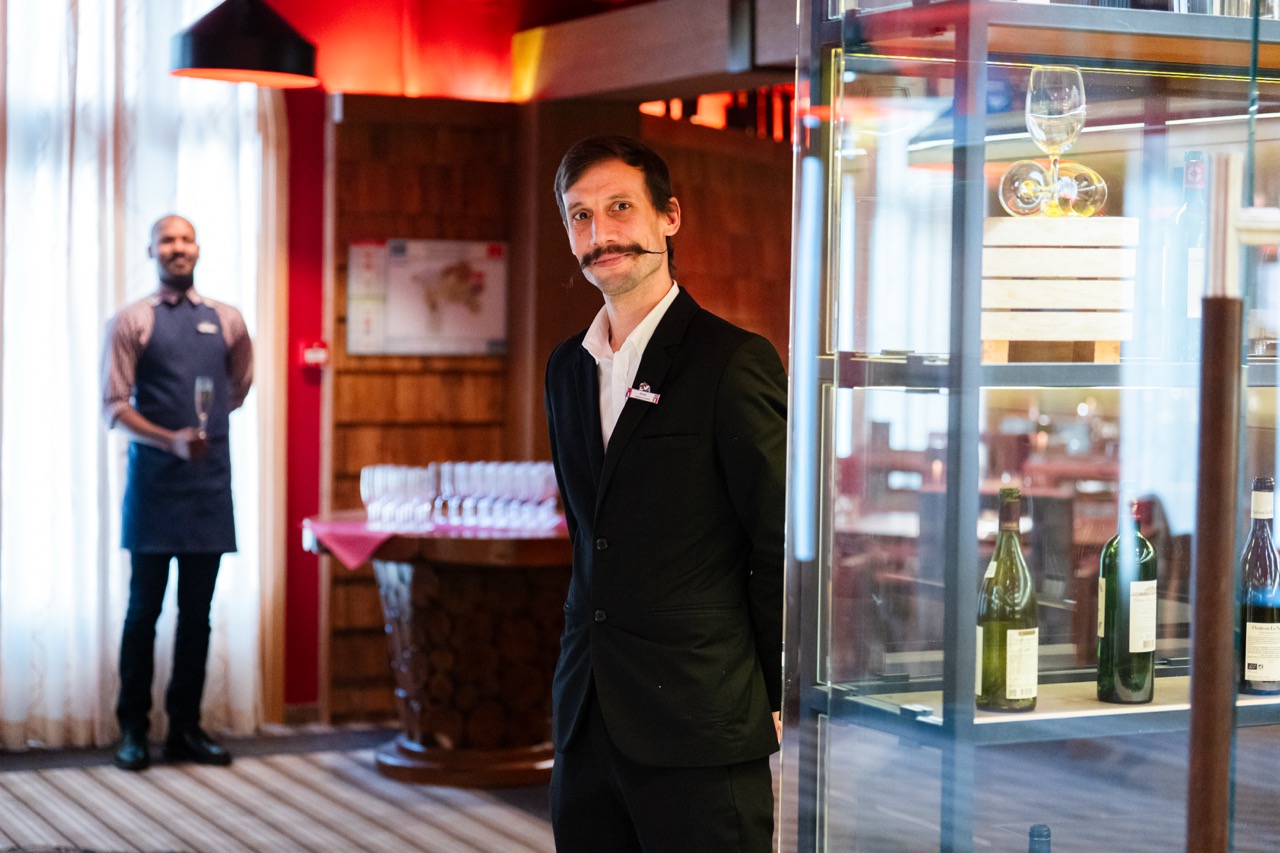 Manager of a restaurant at the entrance of a restaurant