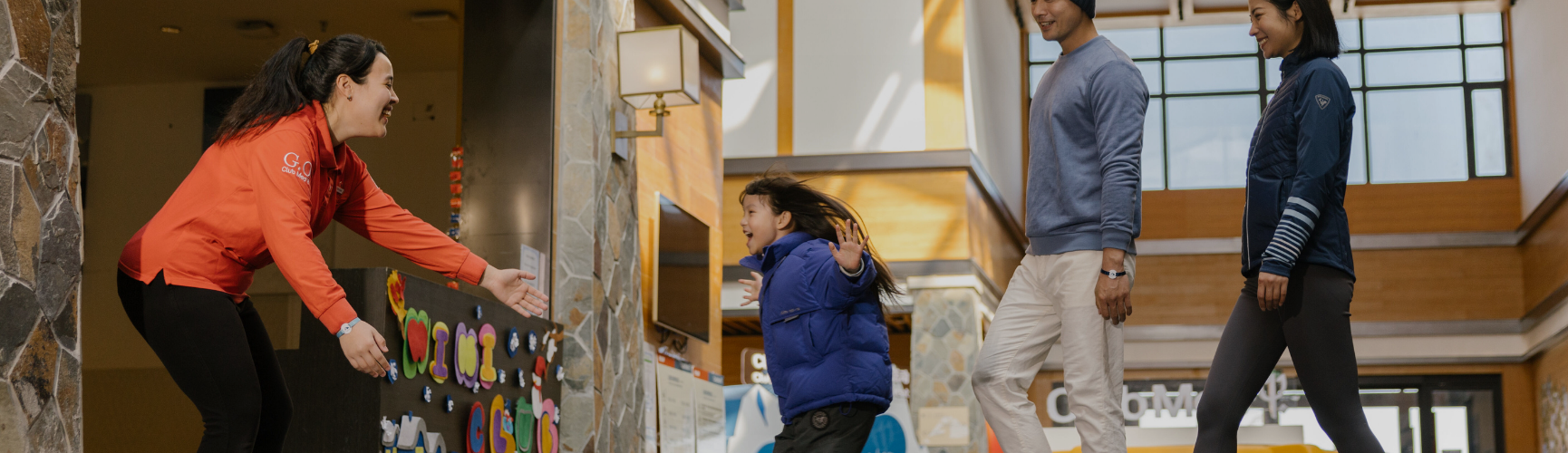 Two Childcare Coordinators having fun with a kid at Club Med