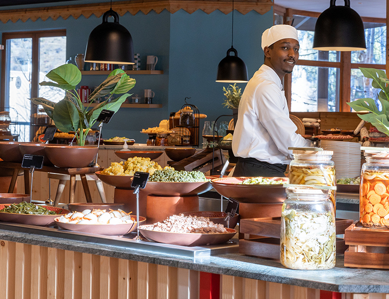 A cook working at a buffet in a ski resort