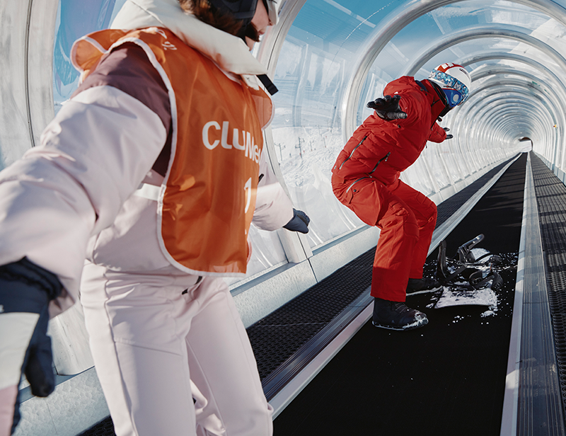 A snowboard instructor teaching a kid