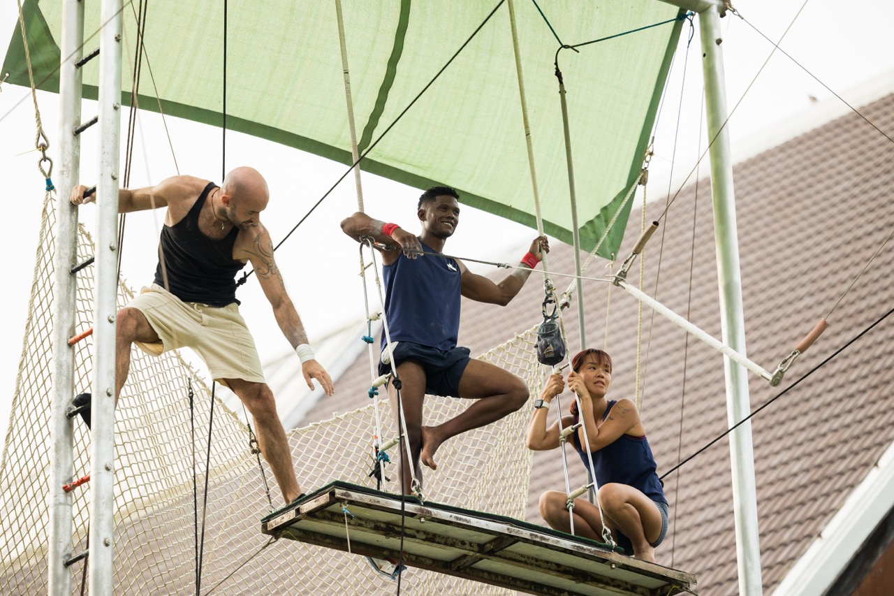 Three team members on a circus platform