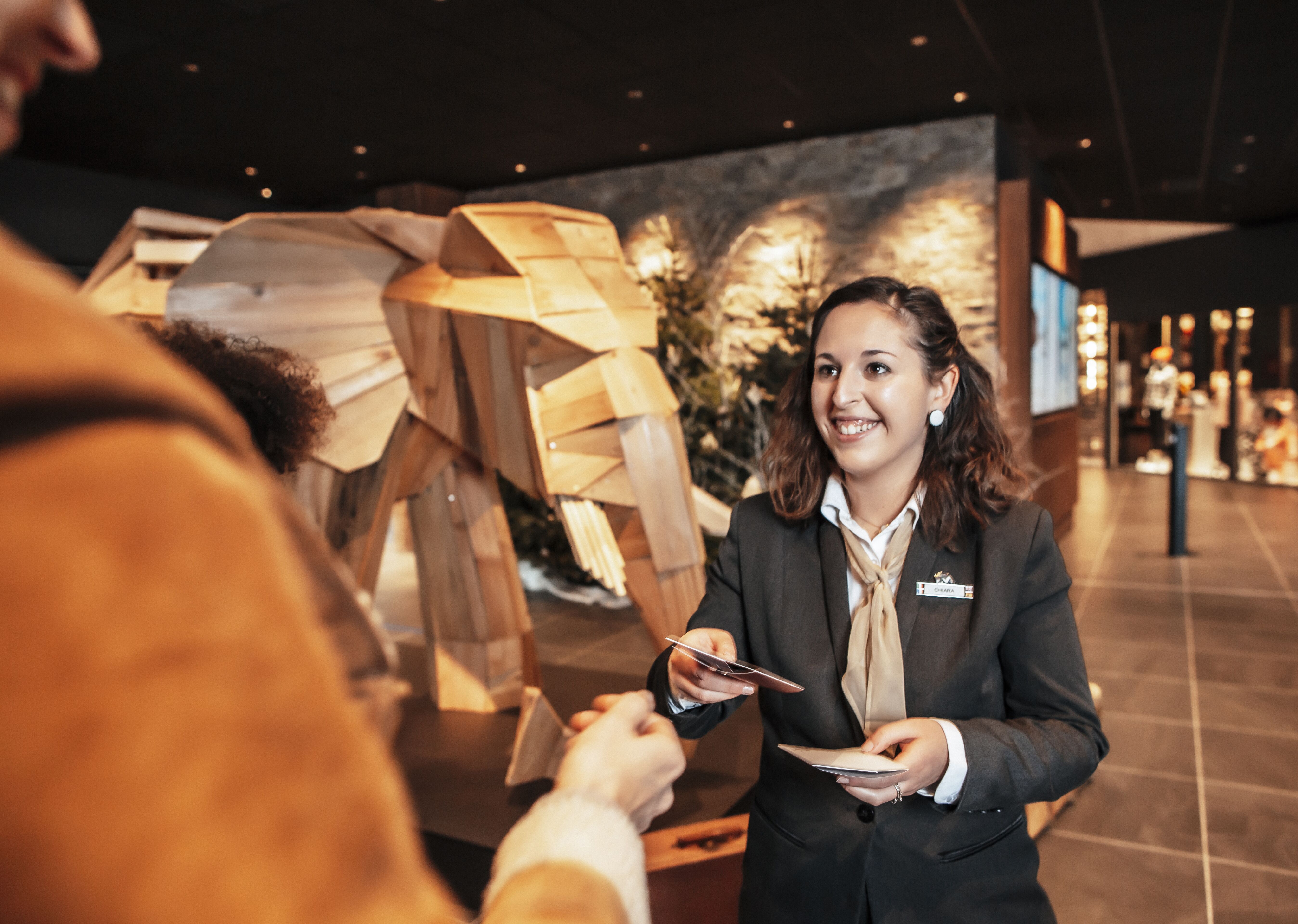 A Receptionist giving a paper to a client