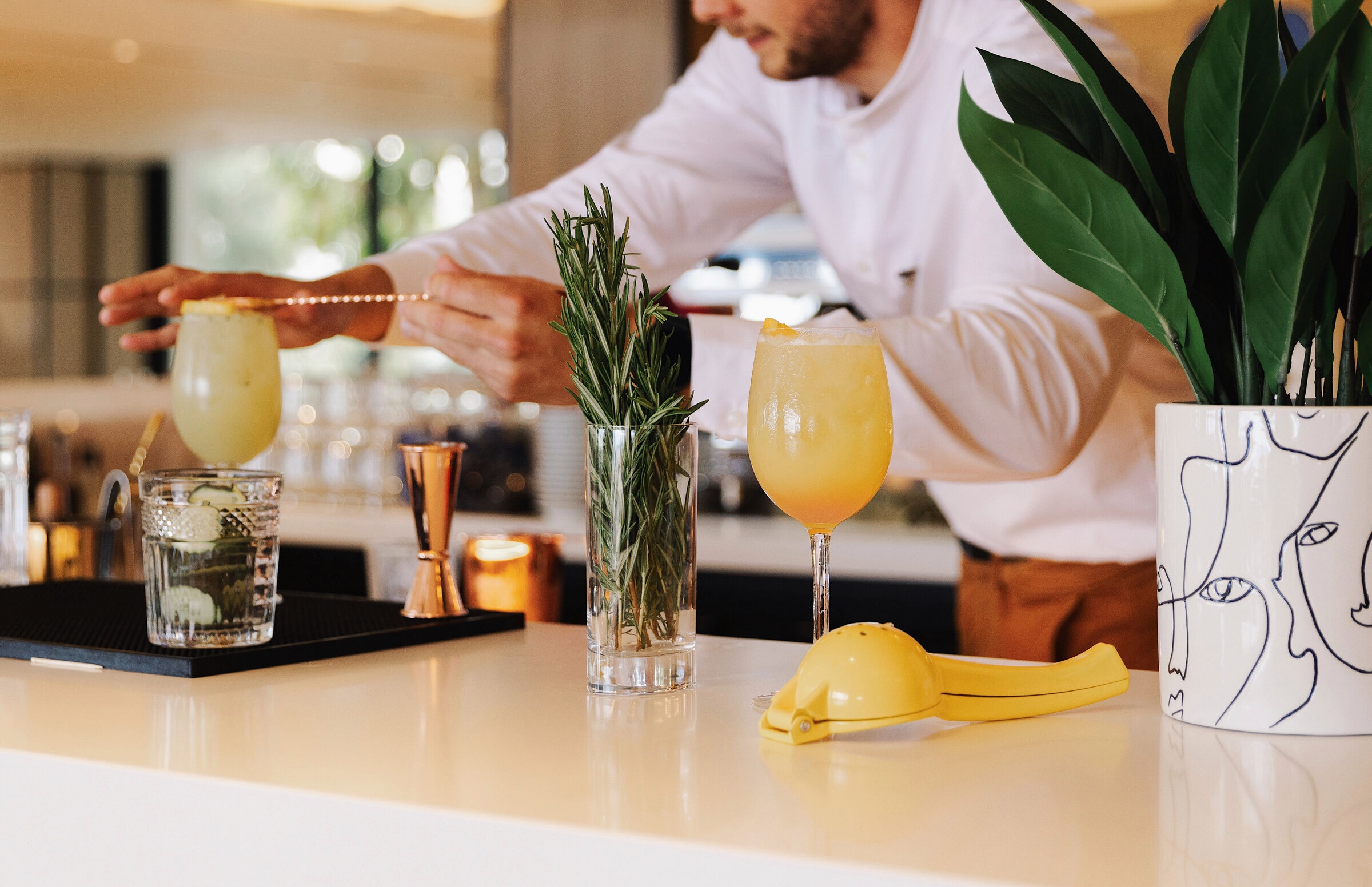 A bartender serving a signature cocktail