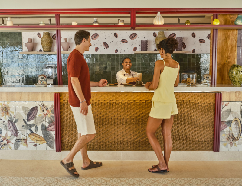 A bartender serving guests at Club Med