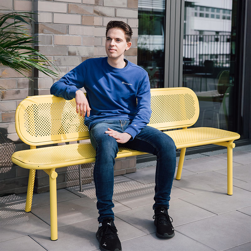 Sanofian sat on a bench outside office