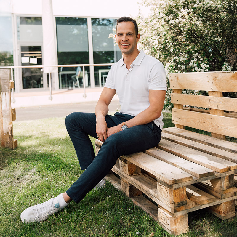 A Sanofian sitting outside of a Sanofi office