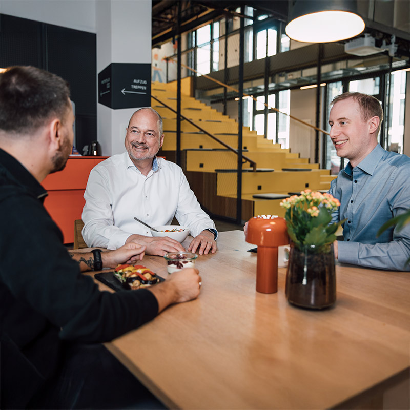Sanofians in office talking during a meeting